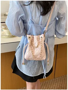 Pink quilted chain bucket bag for women, stylish shoulder crossbody bag with gold hardware.