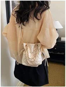 Quilted bucket shoulder bag for women, luxury chain crossbody bag, elegant commuter handbag.