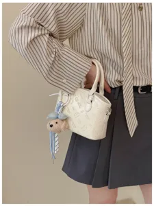 Japanese cartoon printed bucket bag, cute plush bear pendant, stylish leather handbag for women.