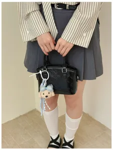 Cartoon print black handbag crossbody bag stylish women daily shoulder bag detailed view.