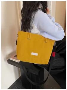 Casual large capacity canvas tote bag with braided handles and shoulder strap for daily use.