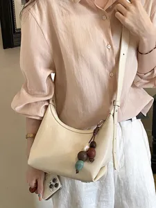 Minimalist neutral beige hobo shoulder bag for women, stylish crossbody and handbag design.