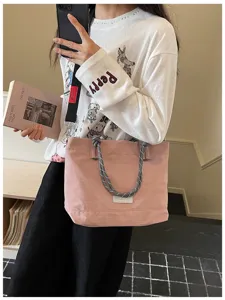 Casual large capacity canvas tote bag with braided handles and stylish crossbody strap for women.