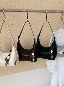 Minimalist underarm shoulder bag for women, chic trendy crossbody handbag with beaded charm.