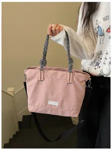 Casual pink large capacity tote bag with rope handles and crossbody strap for daily commute.