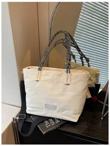 Detailed view of casual large capacity canvas tote bag with unique rope handles and strap.