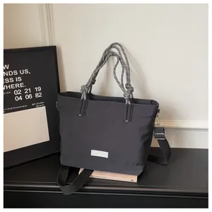 Casual large capacity canvas tote bag with stylish rope handles and shoulder strap for daily use.