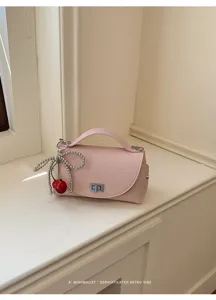 Pink mini shoulder bag with pearl cherry charm, stylish retro handbag for women.