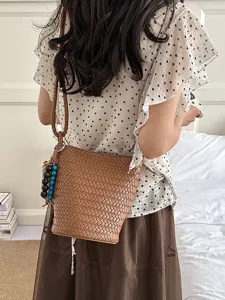 Summer retro woven bucket bag, stylish versatile leather shoulder bag for daily wear.