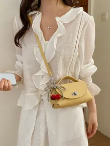 Stylish women crossbody bag with cute cherry bow charm, trendy yellow shoulder handbag for daily.
