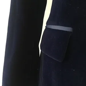Close-up detail of women's velvet blazer pocket and sleeve, showing premium fabric texture.
