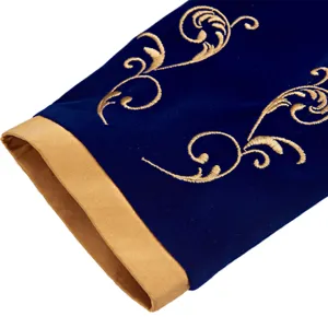 Detailed view of royal blue velvet men's sleeve with intricate gold embroidery and trim.