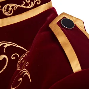 Detailed view of men vintage royal court velvet jacket with gold embroidery and epaulet.