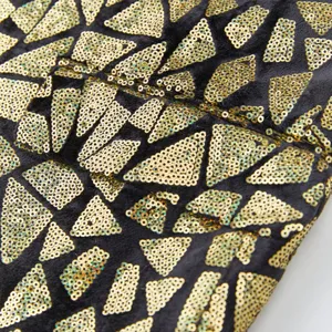 Men's sequin suit jacket fabric detail, featuring geometric triangle pattern for party.
