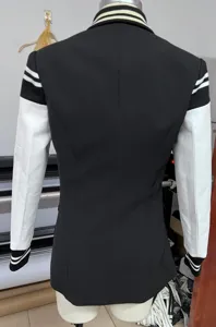 Back detail view of women's color-blocked black and white blazer jacket with ribbed cuffs.