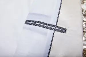 Detailed view of men's fashion sequin suit jacket inner pocket with checkered piping.