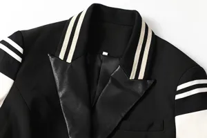 Close-up detail of women colorblocked spliced blazer jacket featuring contrast lapel collar.