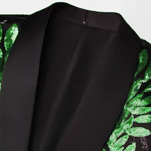 Close-up detail of men black blazer featuring vibrant green sequin leaf pattern and satin lapel.