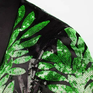 Close-up detail of men's black blazer featuring vibrant green sequin leaf applique.