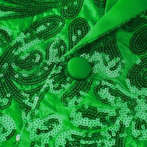 Close-up detail of green sequin blazer showcasing intricate paisley embroidery and satin lapel.