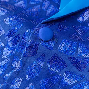 Close-up detail of blue sequin men blazer jacket, showing shiny geometric pattern and button.