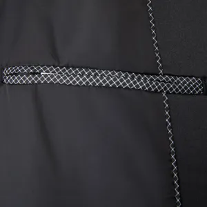 Close-up detail of mens suit jacket pocket and contrast grid seam fine craftsmanship.