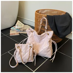 Detailed view of the elegant pink quilted chain tote bag and matching pouch set with metal strap.