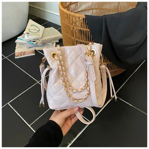 Pink quilted bucket bag with gold chain strap, stylish leather crossbody bag for women.