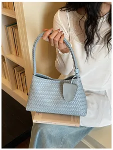 Light blue woven leather shoulder bag detail shot, vintage style designer handbag