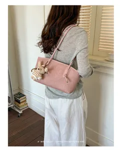 Stylish pink canvas tote bag for women, large capacity shoulder bag with cute bear pendant.
