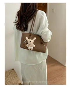Stylish large capacity brown tote bag with cute plush charm, perfect for daily commuting.