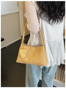 Detailed view of the stylish woven leather shoulder bag showcasing texture and elegant underarm fit.