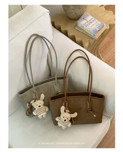 Stylish large capacity tote shoulder bag with cute bear pendant for daily commuting.