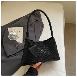 Detailed view of retro woven shoulder bag, elegant black hobo bag for women chic daily use.