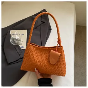 Orange woven leather shoulder bag, vintage underarm handbag, elegant casual tote for women.