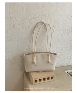 Minimalist retro PU leather shoulder tote bag, stylish commuter underarm bag for daily use.