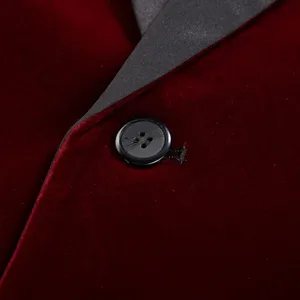 Burgundy velvet blazer detail showing black satin shawl lapel and button craftsmanship.