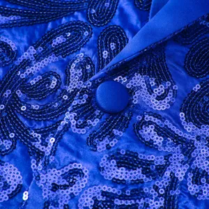 Close-up detail of royal blue sequin blazer featuring paisley pattern and satin lapel.