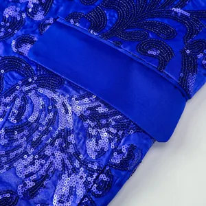 Close-up detail of royal blue sequin blazer jacket with elegant embroidered swirling patterns.