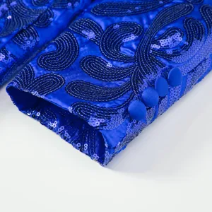 Royal blue sequin suit sleeve detail closeup, men formal blazer cuff with cloth buttons