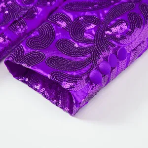 Close-up detail of purple sequin blazer cuff with intricate embroidery and matching fabric buttons.