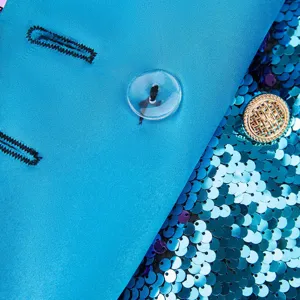 Primer plano detallado de un blazer de lentejuelas azules con lentejuelas brillantes y ojal.