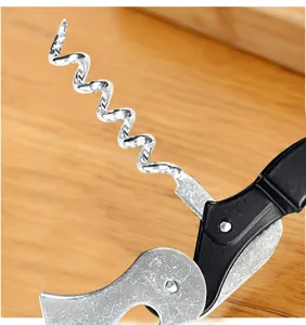 Close-up detail of stainless steel corkscrew spiral and lever mechanism for wine opening.