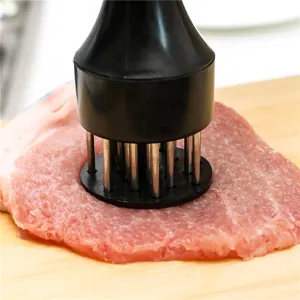 Stainless steel meat tenderizer kitchen tool with sharp needles for steak and meat preparation.