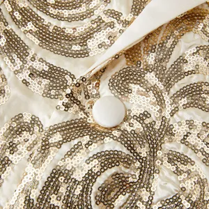 Men's sequin blazer detail shot, featuring shiny gold patterns, satin lapel, and elegant button.