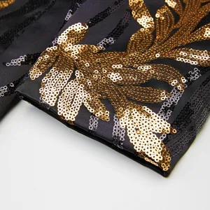 Gold sequin embroidered sleeve detail of mens luxury party blazer jacket close up view