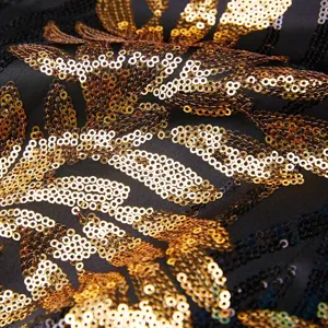 Gold sequin fabric detail macro shot of men's blazer, luxury sparkling material close up