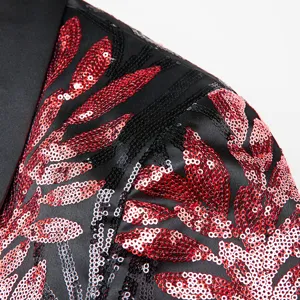 Close-up detail of mens black blazer featuring striking red and black sequin leaf applique design.