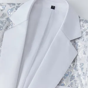 Close-up detail of white men suit jacket featuring sparkling silver triangular sequin lapels.