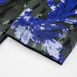 Men sequin blazer sleeve detail close up, glamorous blue sparkling embroidered stage costume.